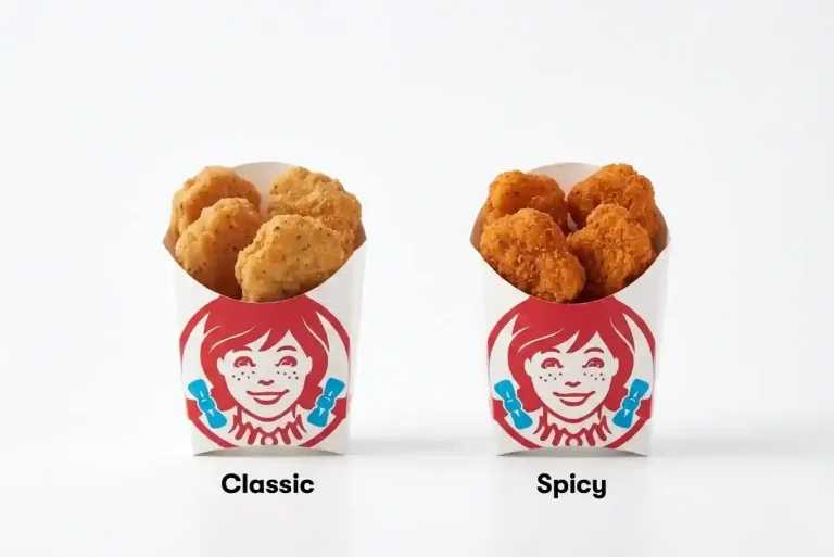 Wendy's Chicken Nuggets Price - 4pc, 6pc, 10pc and 20pc Guide (2026) 2 Wendy's classic chicken nuggets on the left vs spicy chicken nuggets on the right